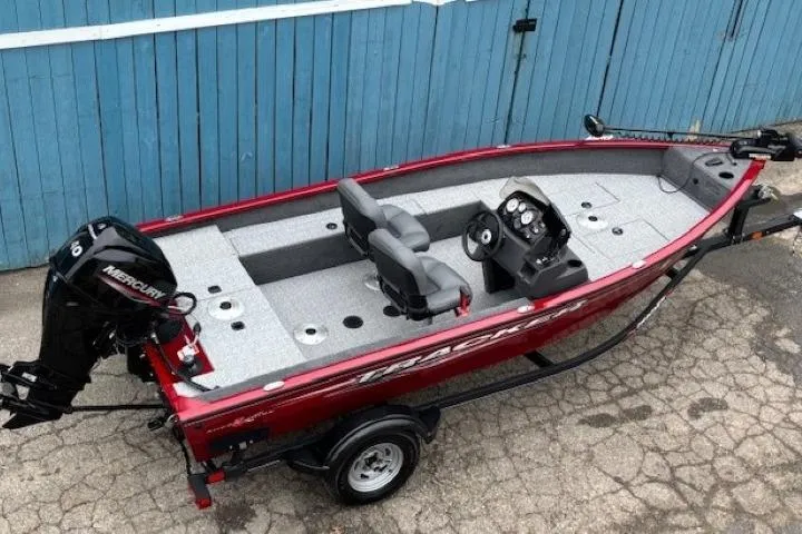 Slide: The Image of 2021 Tracker Super Guide V-16 SC fishing boat with Mercury engine, red exterior. - 7
