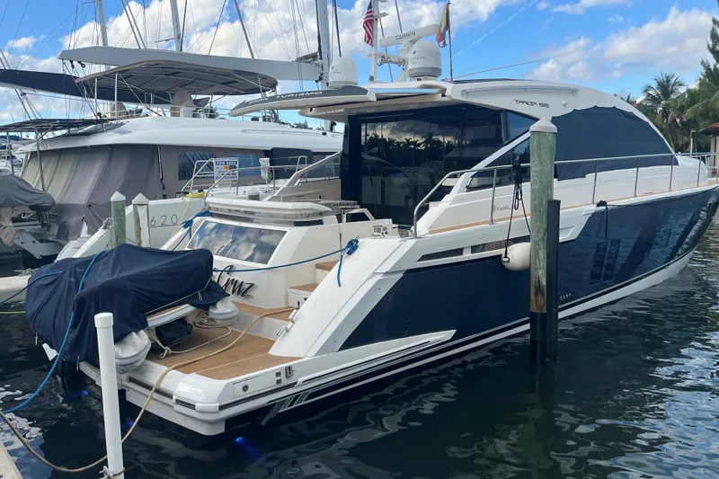 Slide: The Image of 2012 Fairline Targa 58 Gran Turismo yacht docked at marina, blue and white exterior. - 1