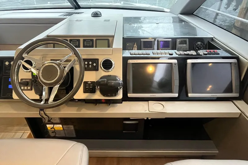 Slide: The Image of Cockpit of 2012 Fairline Targa 58 Gran Turismo with steering wheel and navigation screens. - 18