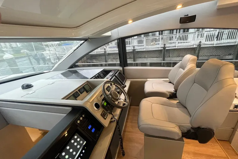 Slide: The Image of Interior of 2012 Fairline Targa 58 Gran Turismo yacht, featuring modern helm and seating. - 20