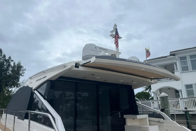 Slide: The Image of 2012 Fairline Targa 58 Gran Turismo yacht docked near waterfront home. - 3