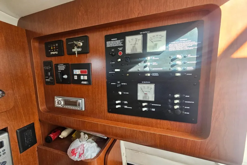 Slide: The Image of Control panel of a 2006 Pro-Line 32 Express boat with various switches and gauges. - 11