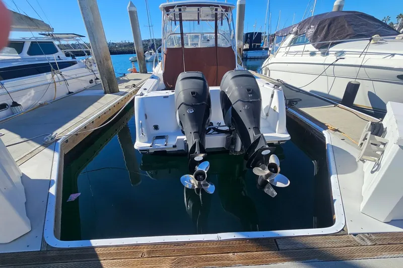 Slide: The Image of 2006 Pro-Line 32 Express boat with dual outboard motors docked at marina. - 3