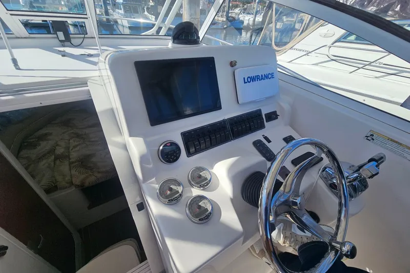 Slide: The Image of 2006 Pro-Line 32 Express boat dashboard with steering wheel and navigation controls. - 5