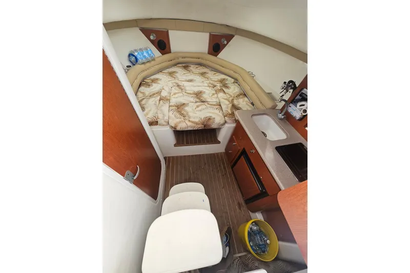 Slide: The Image of 2006 Pro-Line 32 Express cabin interior with bed, kitchenette, and seating area. - 7
