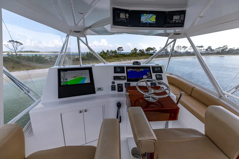 Slide: The Image of Helm of 2000 Custom Carolina Alex Willis Convertible yacht with navigation screens and steering wheel. - 21