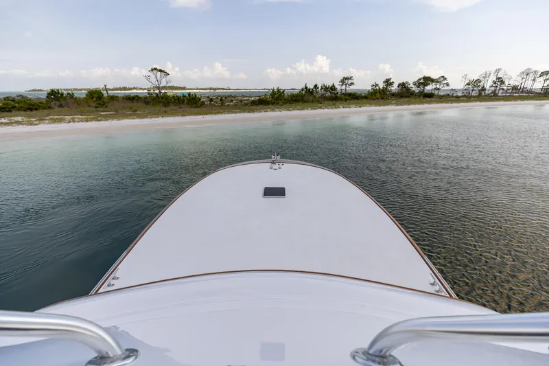 Slide: The Image of Bow view of 2000 Custom Carolina Alex Willis Convertible near a serene shoreline. - 25