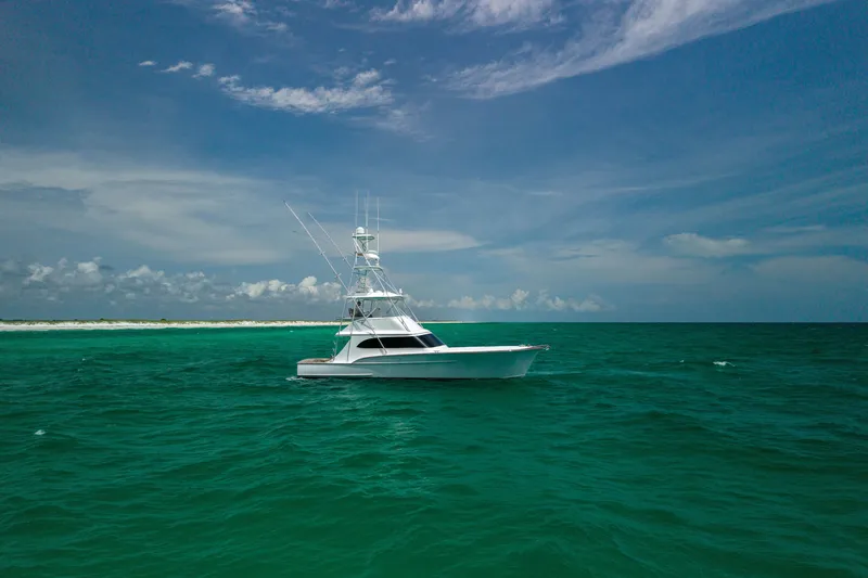 Slide: The Image of Custom Carolina Alex Willis Convertible 2000 yacht on turquoise ocean under blue sky. - 29