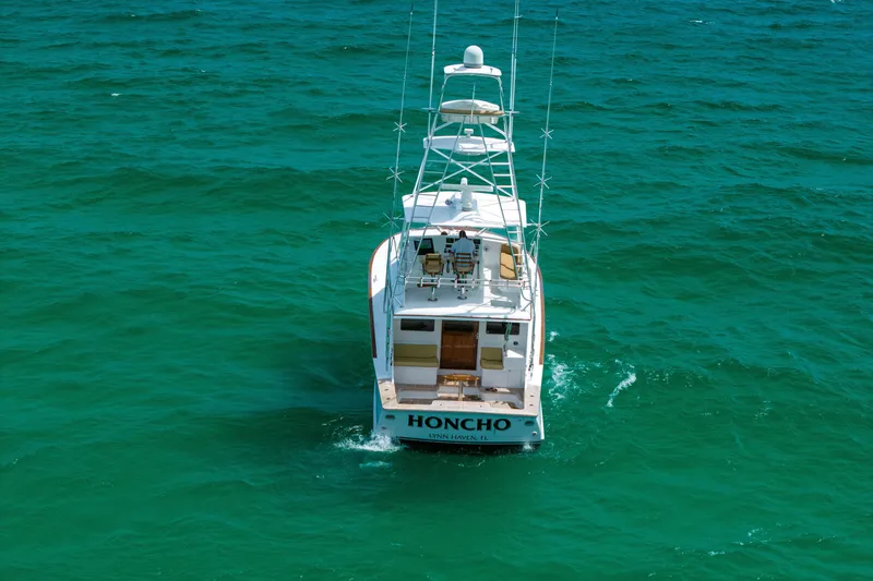 Slide: The Image of Custom Carolina Alex Willis Convertible 2000 boat on turquoise ocean waters. - 30