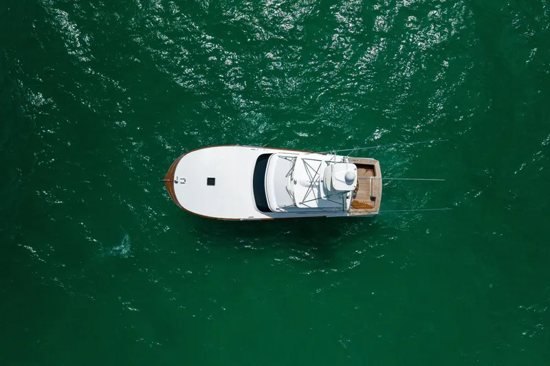 Slide: The Image of Aerial view of 2000 Custom Carolina Alex Willis Convertible boat on green water. - 31