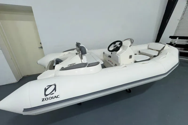 The Image of 2026 Zodiac Yachtline 400 inflatable boat in a showroom, featuring sleek design and modern controls. - 0