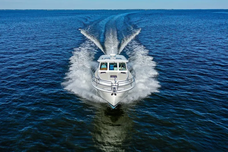 Slide: The Image of 2027 Sabre 38 Salon Express cruising on open water, creating a dynamic wake. - 4