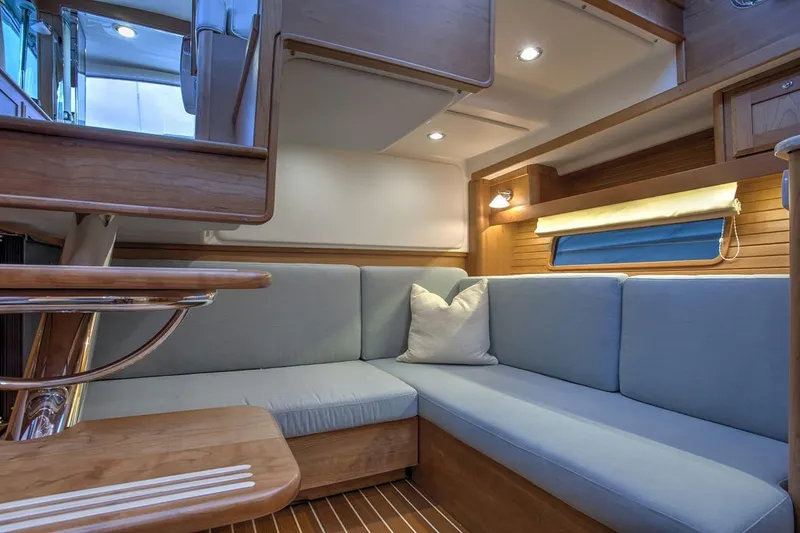 Slide: The Image of 2027 Sabre 38 Salon Express interior with cozy seating and elegant wooden finishes. - 8