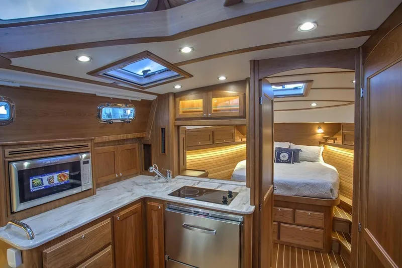 Slide: The Image of Luxurious interior of 2027 Sabre 38 Salon Express yacht with modern kitchen and cozy bedroom. - 9