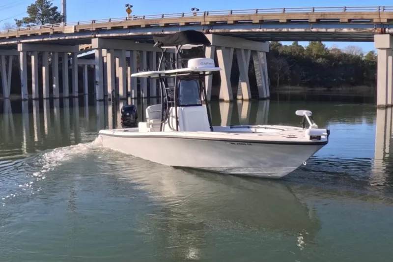 The Image of 2017 Baker Boatworks 26 Open cruising under a bridge on calm water. - 1