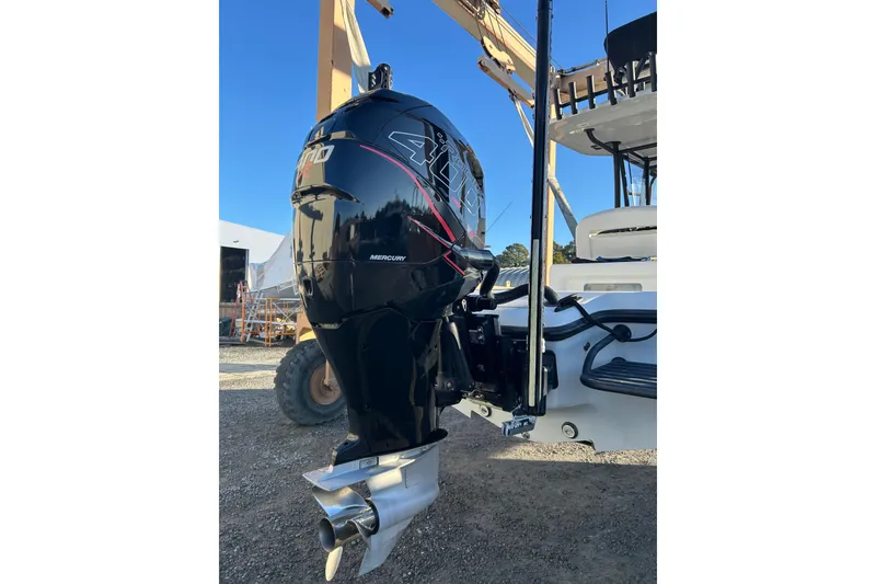 Slide: The Image of 2017 Baker Boatworks 26 Open with Mercury outboard engine, parked outdoors. - 14