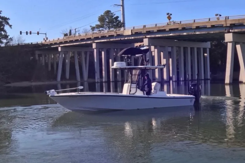 Slide: The Image of 2017 Baker Boatworks 26 Open cruising under a bridge on a calm river. - 3