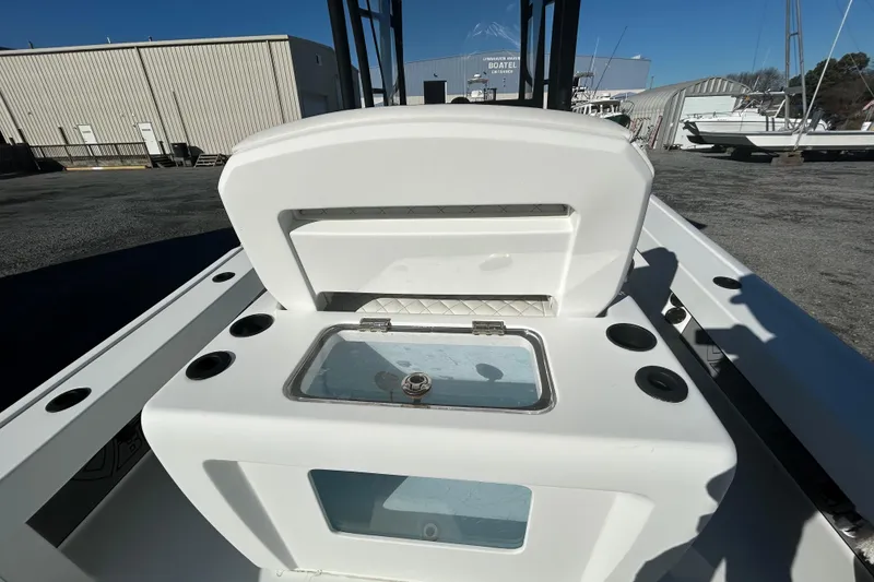 Slide: The Image of 2017 Baker Boatworks 26 Open with open storage compartment, docked at a marina. - 12