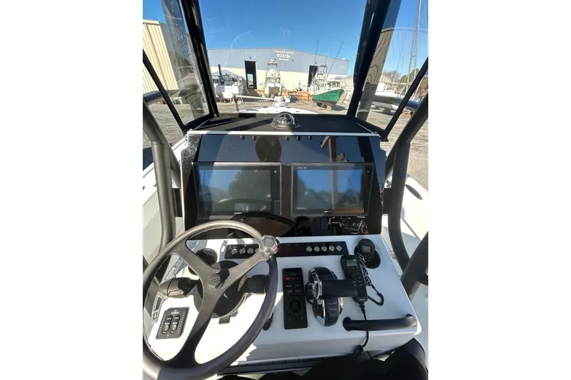 Slide: The Image of Cockpit of 2017 Baker Boatworks 26 Open with modern navigation equipment and steering wheel. - 4