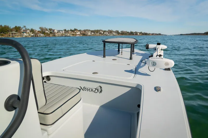 Slide: The Image of 2021 Drake Nomad boat on calm water, featuring sleek design and comfortable seating. - 10