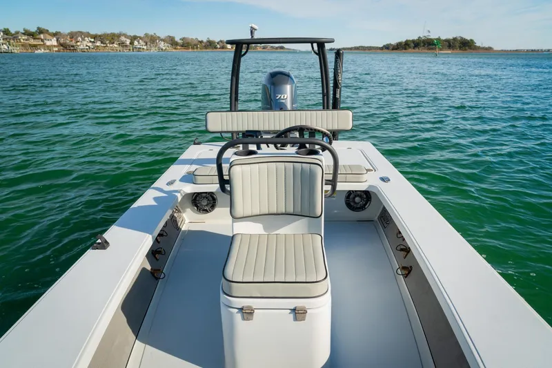 Slide: The Image of 2021 Drake Nomad boat on calm water, featuring sleek seating and modern design. - 12