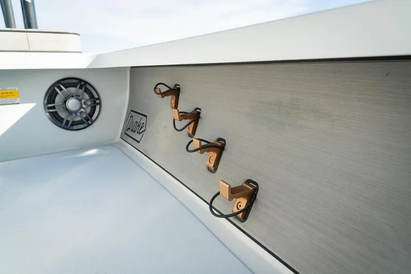 Slide: The Image of 2021 Drake Nomad boat interior with speaker and hooks on a sleek panel. - 13