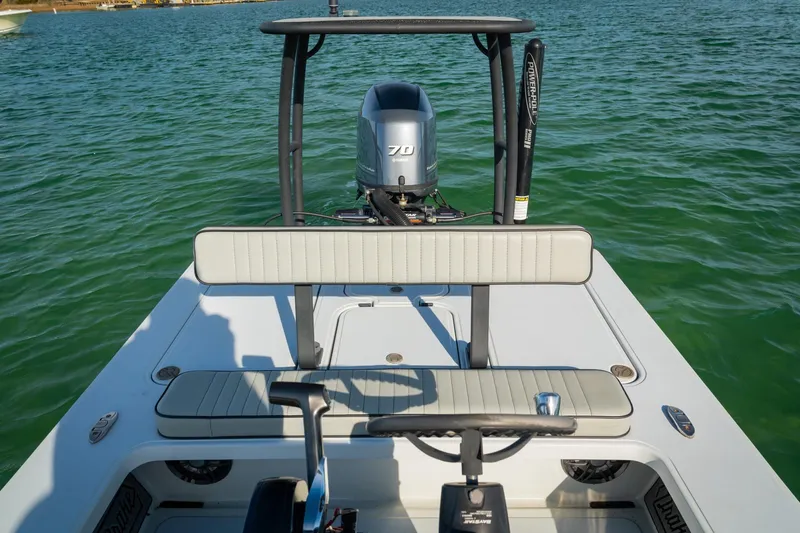 Slide: The Image of 2021 Drake Nomad boat with outboard motor on calm water. - 14