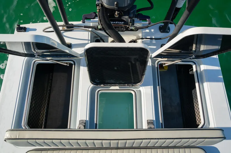 Slide: The Image of 2021 Drake Nomad boat storage compartments with open hatches, showcasing interior design. - 15