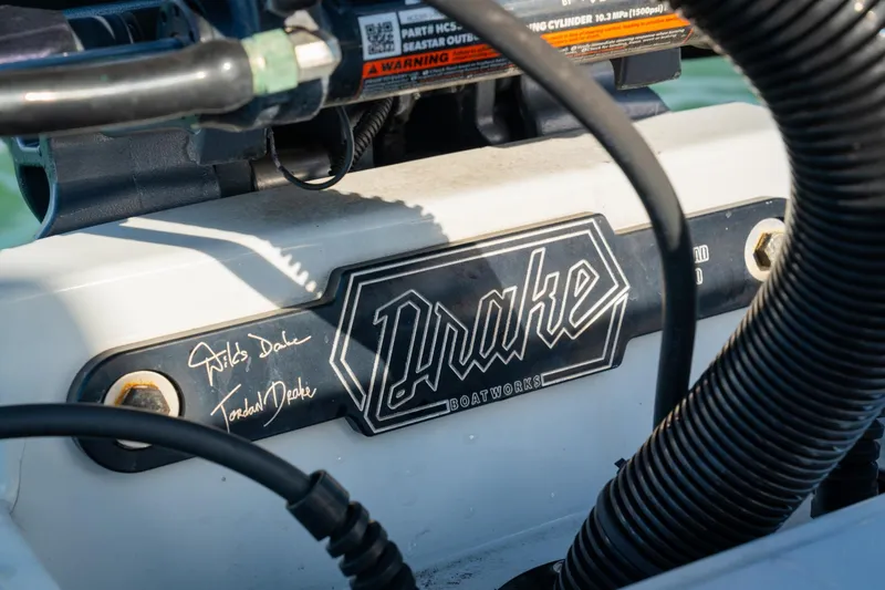 Slide: The Image of 2021 Drake Nomad boat engine detail with logo and signatures. - 16