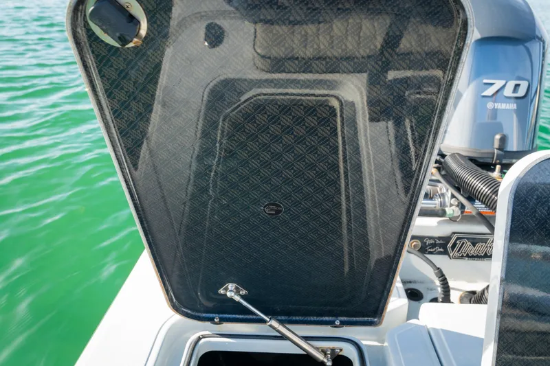 Slide: The Image of Open hatch on 2021 Drake Nomad boat with Yamaha 70 engine in background. - 17