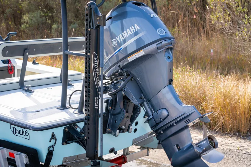 Slide: The Image of 2021 Drake Nomad boat with Yamaha outboard motor in natural setting. - 18