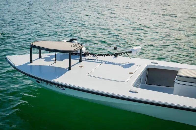Slide: The Image of 2021 Drake Nomad boat on calm water, featuring a sleek design and modern equipment. - 6