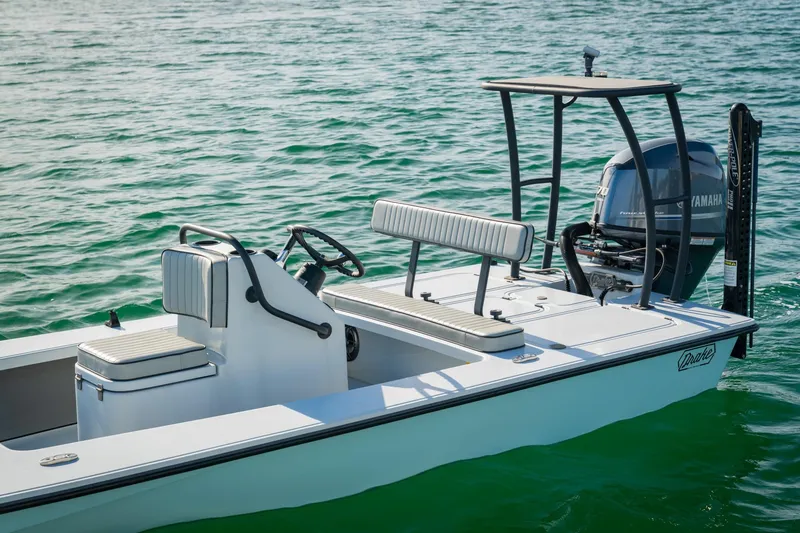 Slide: The Image of 2021 Drake Nomad boat on water, featuring Yamaha engine and sleek design. - 7