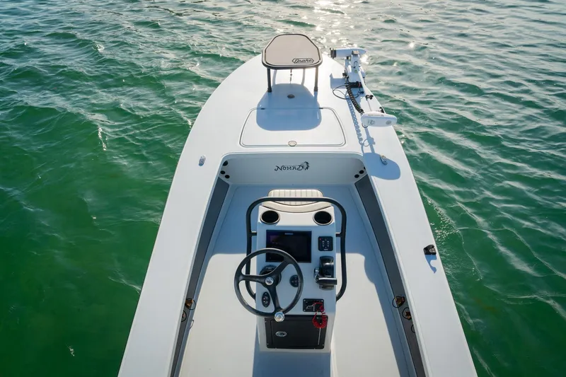 Slide: The Image of 2021 Drake Nomad boat on calm water, featuring a sleek design and modern controls. - 8