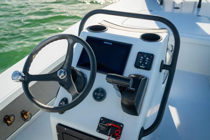Slide: The Image of Steering console of 2021 Drake Nomad boat with navigation controls and display. - 9