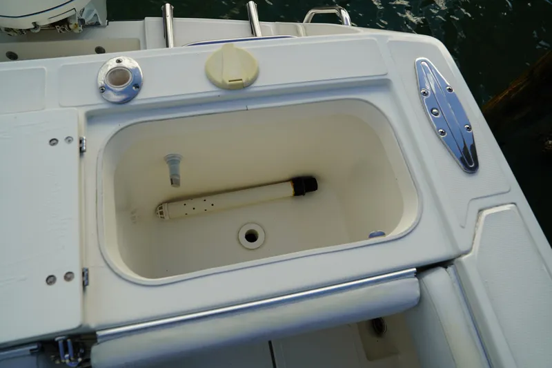 Slide: The Image of Livewell compartment on a 2013 Stamas 317 Tarpon boat, featuring a clean, white interior. - 12