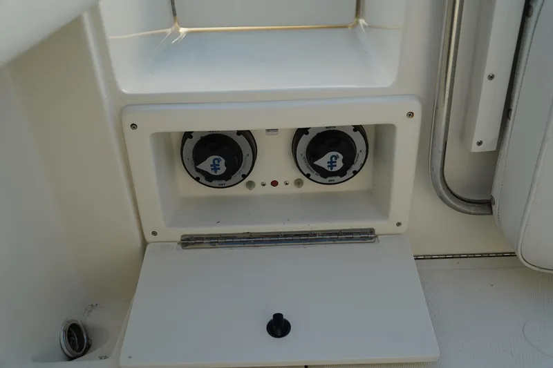 Slide: The Image of 2013 Stamas 317 Tarpon boat control panel with dual switches and storage compartment. - 15