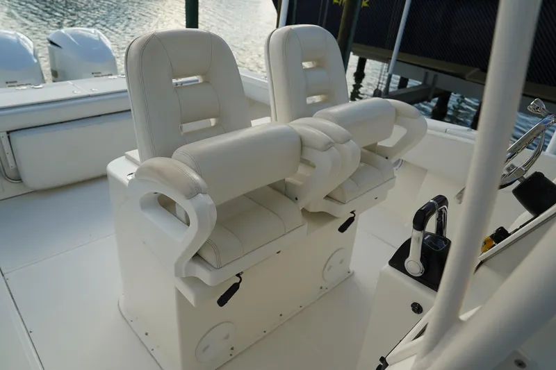 Slide: The Image of 2013 Stamas 317 Tarpon boat interior with dual white captain's chairs and control console. - 18