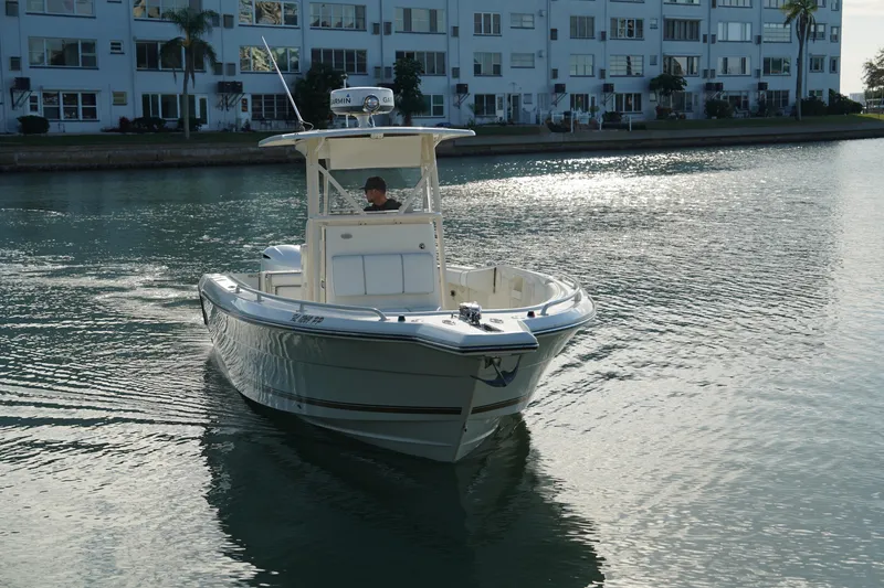 Slide: The Image of 2013 Stamas 317 Tarpon boat cruising near waterfront buildings. - 2