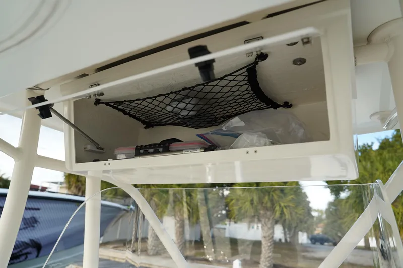 Slide: The Image of Storage compartment on 2013 Stamas 317 Tarpon boat with netting and items inside. - 20