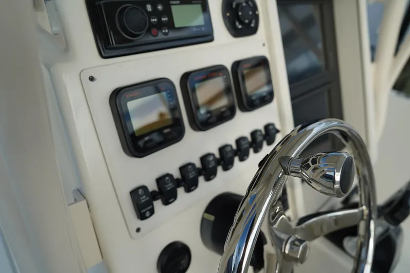 Slide: The Image of Control panel of 2013 Stamas 317 Tarpon boat with steering wheel and electronic displays. - 21