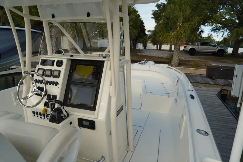 Slide: The Image of 2013 Stamas 317 Tarpon boat cockpit with steering wheel and navigation controls. - 22
