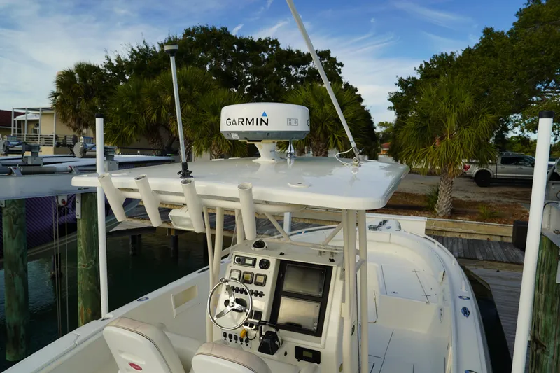 Slide: The Image of 2013 Stamas 317 Tarpon boat with Garmin radar, docked near palm trees. - 26