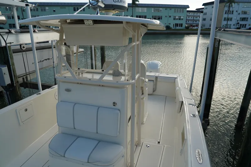 Slide: The Image of 2013 Stamas 317 Tarpon boat docked, featuring a spacious deck and seating area. - 27