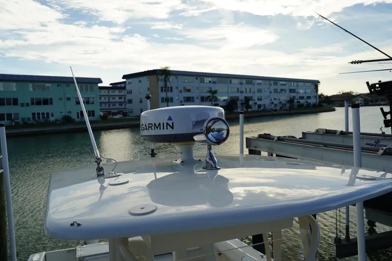 Slide: The Image of 2013 Stamas 317 Tarpon boat with Garmin radar, docked near waterfront buildings. - 30