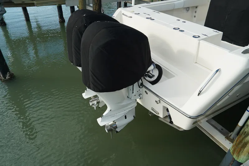 Slide: The Image of 2013 Stamas 317 Tarpon boat with dual covered outboard motors at dock. - 38