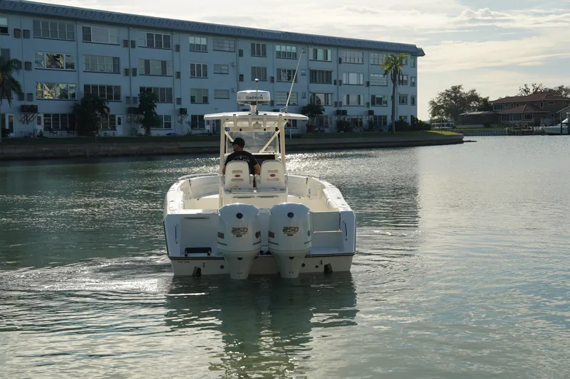 Slide: The Image of 2013 Stamas 317 Tarpon boat cruising near waterfront buildings. - 4
