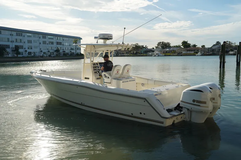 Slide: The Image of 2013 Stamas 317 Tarpon boat with dual Yamaha engines on calm water. - 5