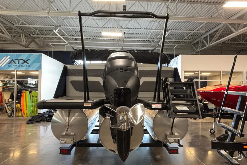 Slide: The Image of 2026 Viaggio Z24U pontoon boat with outboard motor in showroom setting. - 2