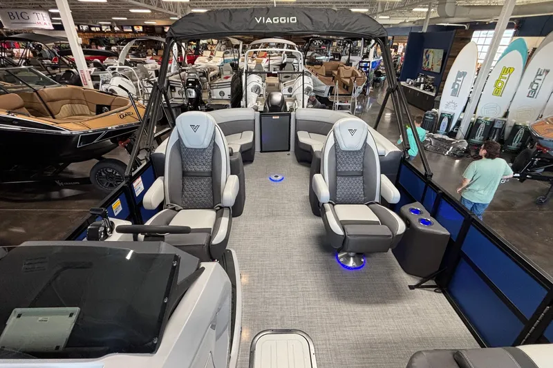 Slide: The Image of 2026 Viaggio Z24U pontoon boat interior with luxury seating and modern design in showroom. - 21